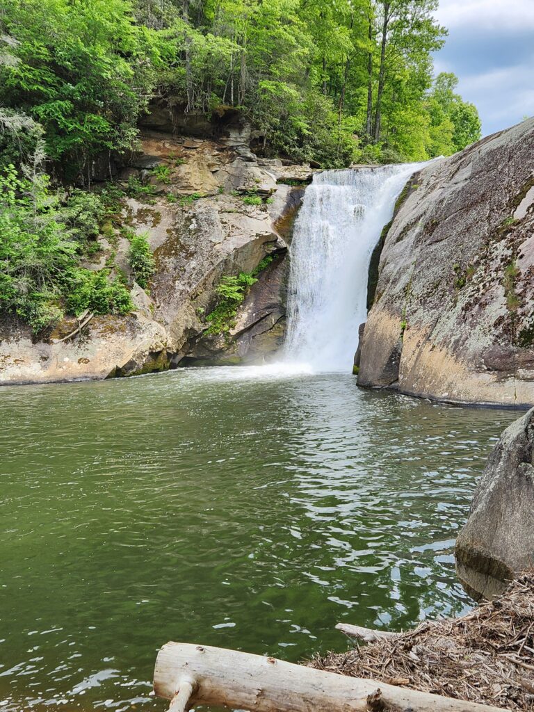 Waterfall into a deep green pool